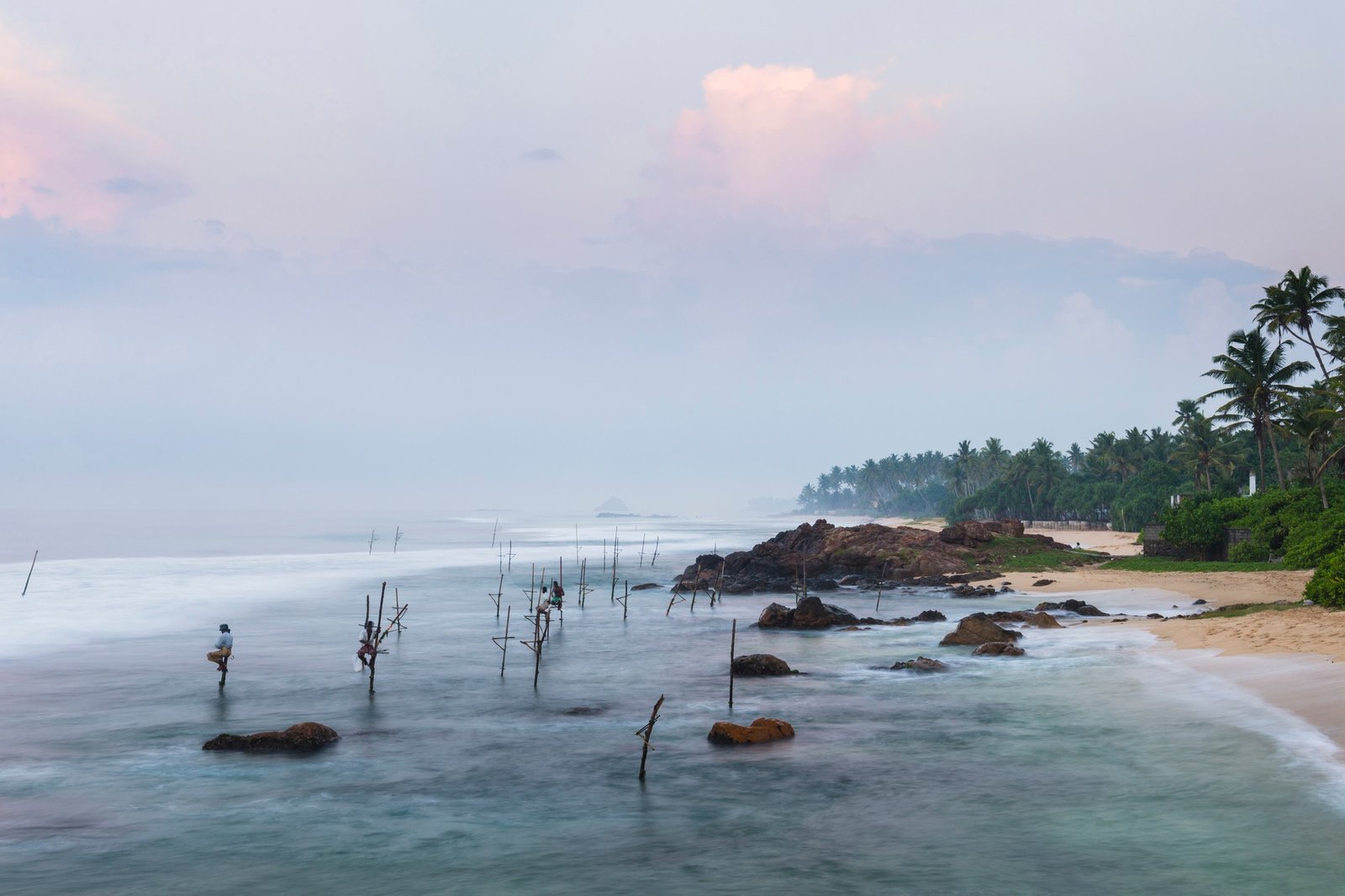 Stilt fishing, stilt fishermen at Midigama Beach, near Weligama, South Coast, Sri Lanka, Asia